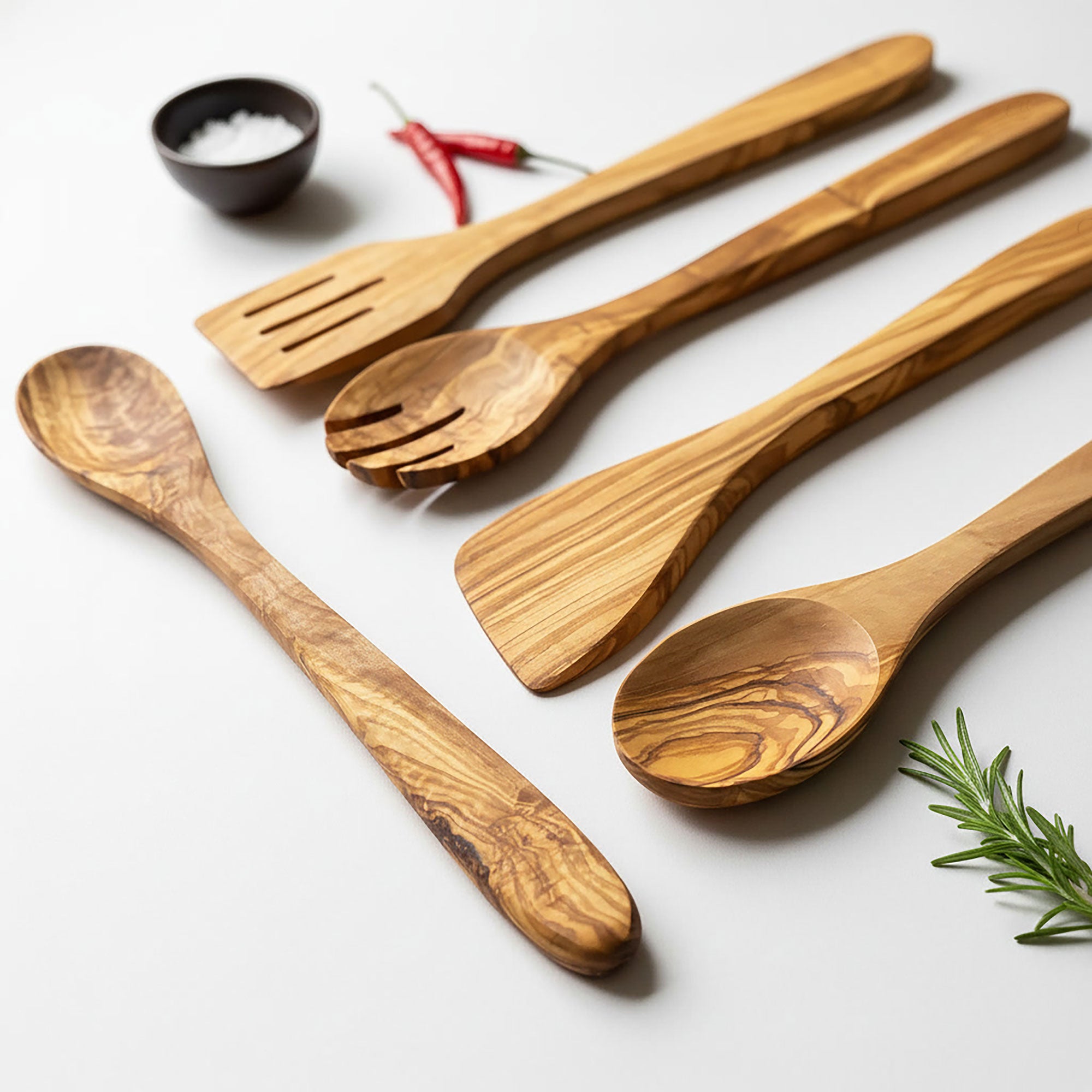Set of wooden utensils including spoons and a spatula on a light background.