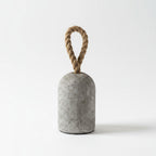 Concrete doorstop with a rope handle on a white background
