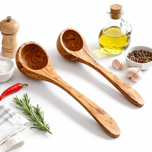 Wooden ladles on a white surface with kitchen items like oil, salt, and herbs.