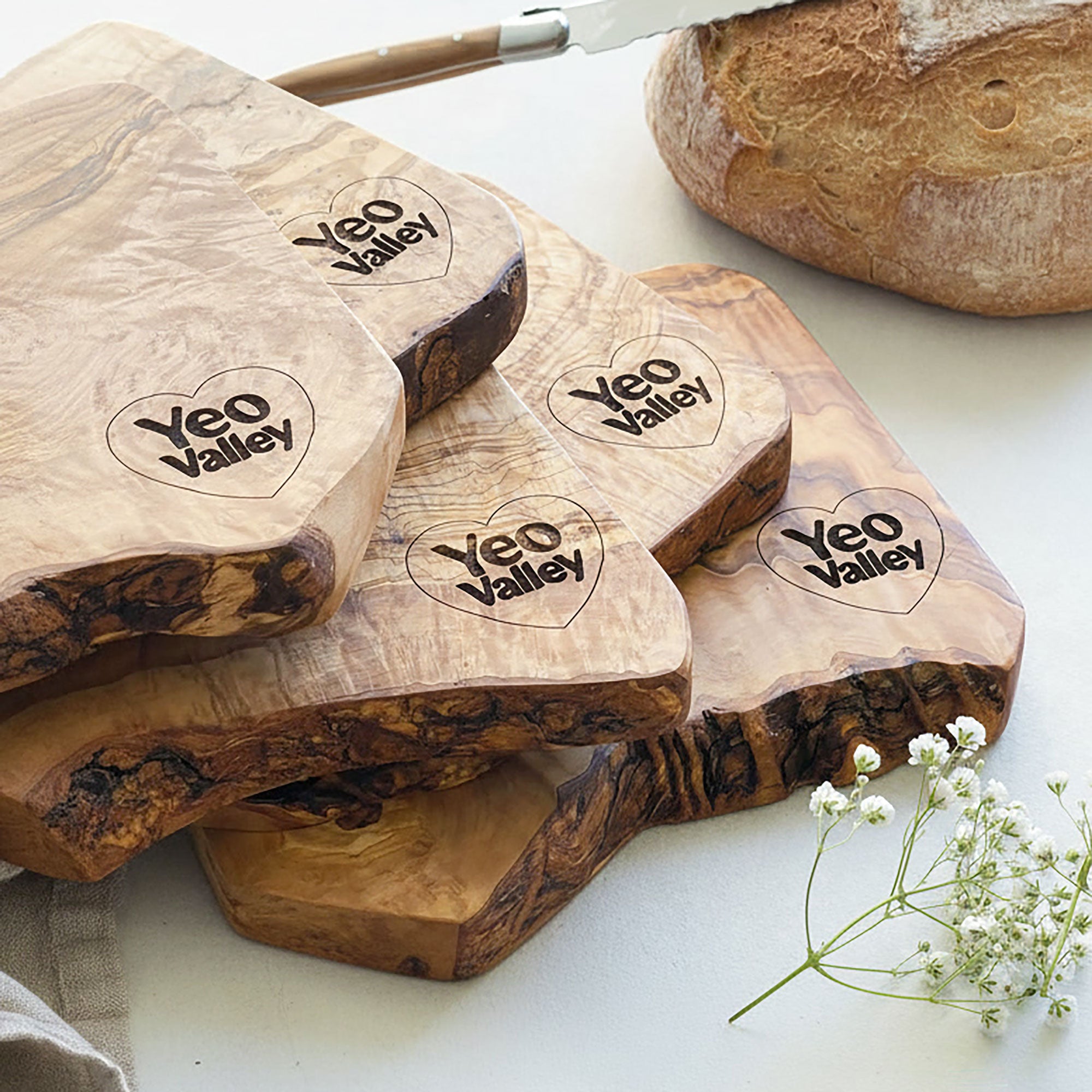 Wooden cutting boards with 'Yeo Valley' branding on a white surface.