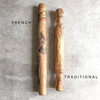 two olive wood rolling pins side-by-side on a light grey surface showcasing the variation between a french style rolling pin and a traditional rolling pin.