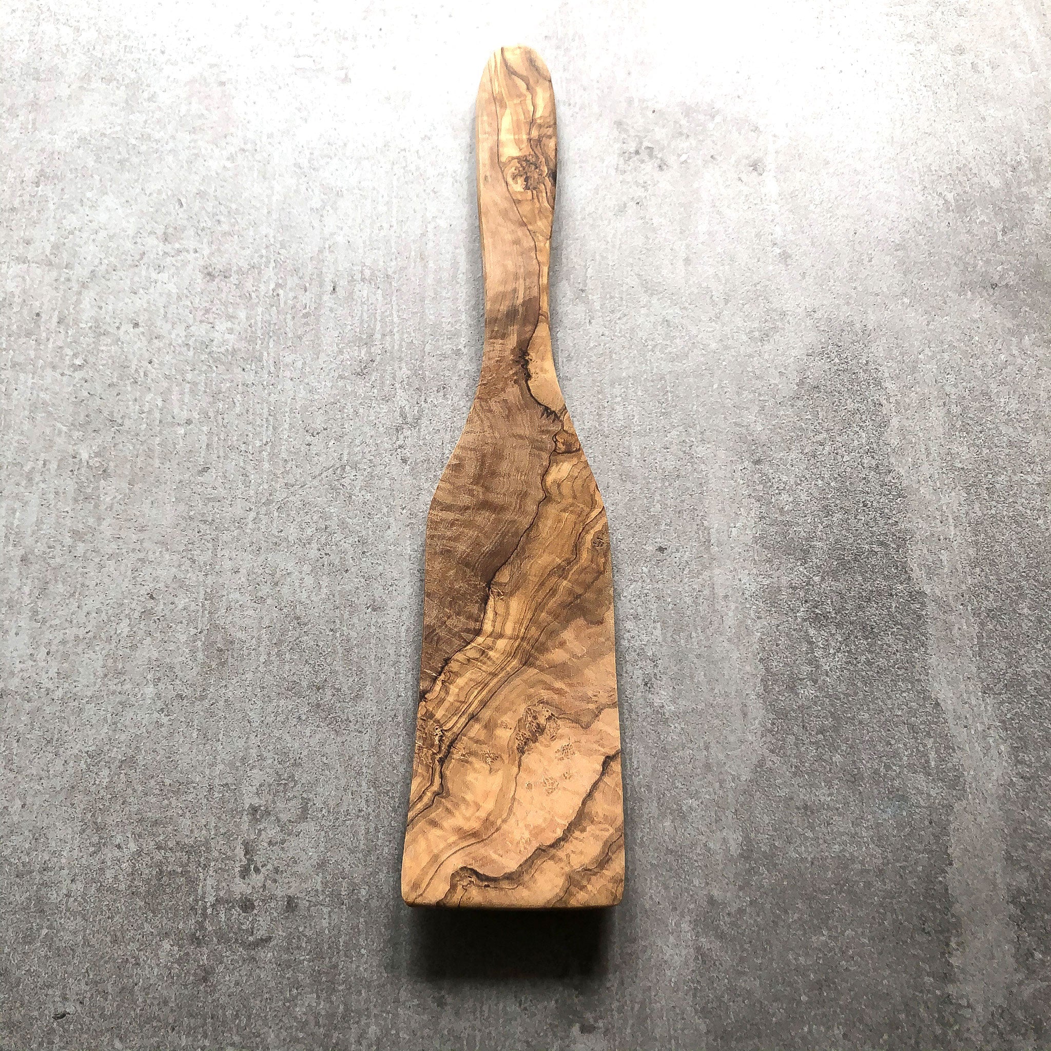 wooden spatula on a grey surface